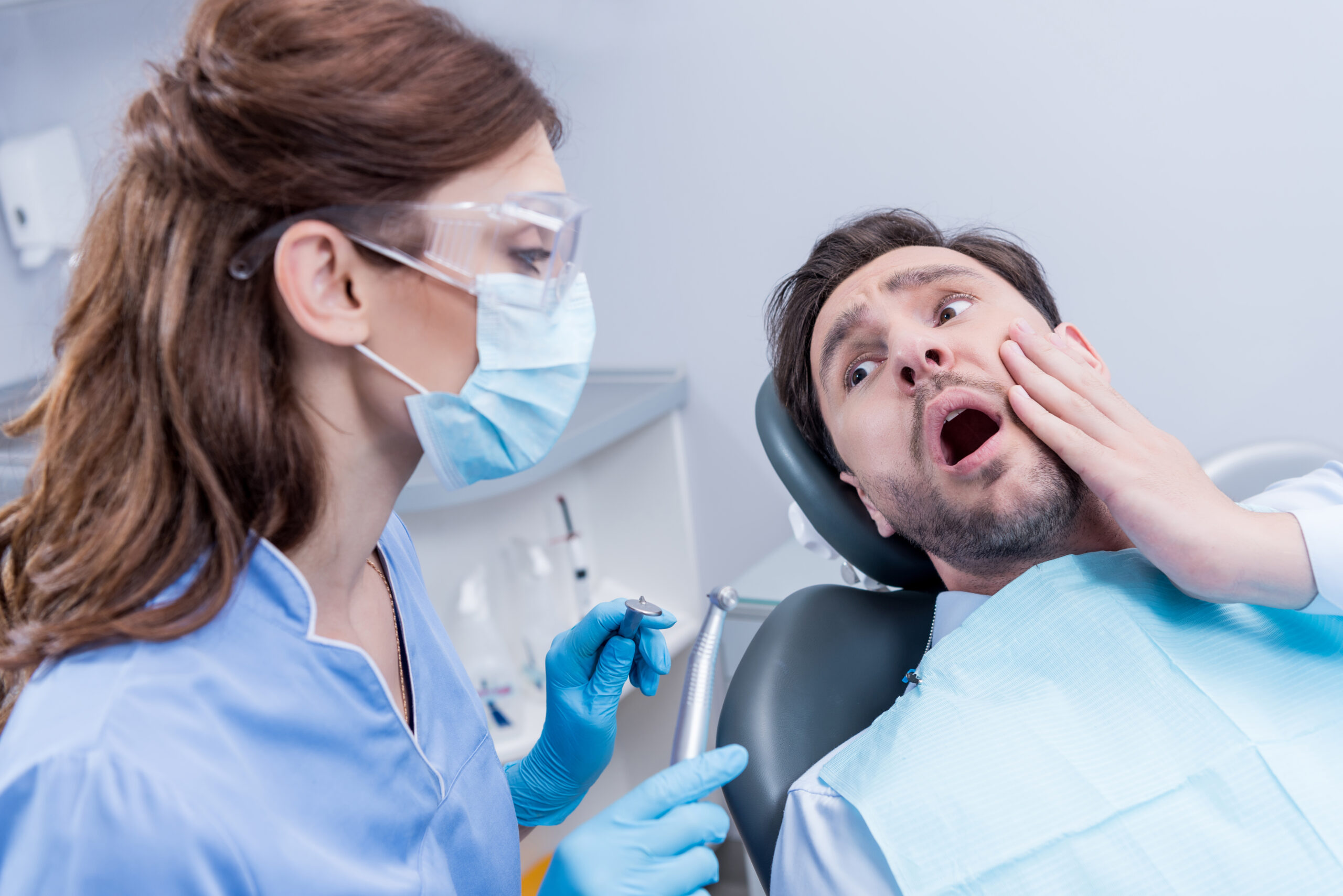 Patient experiencing a broken tooth visiting an emergency dentist Spring TX.